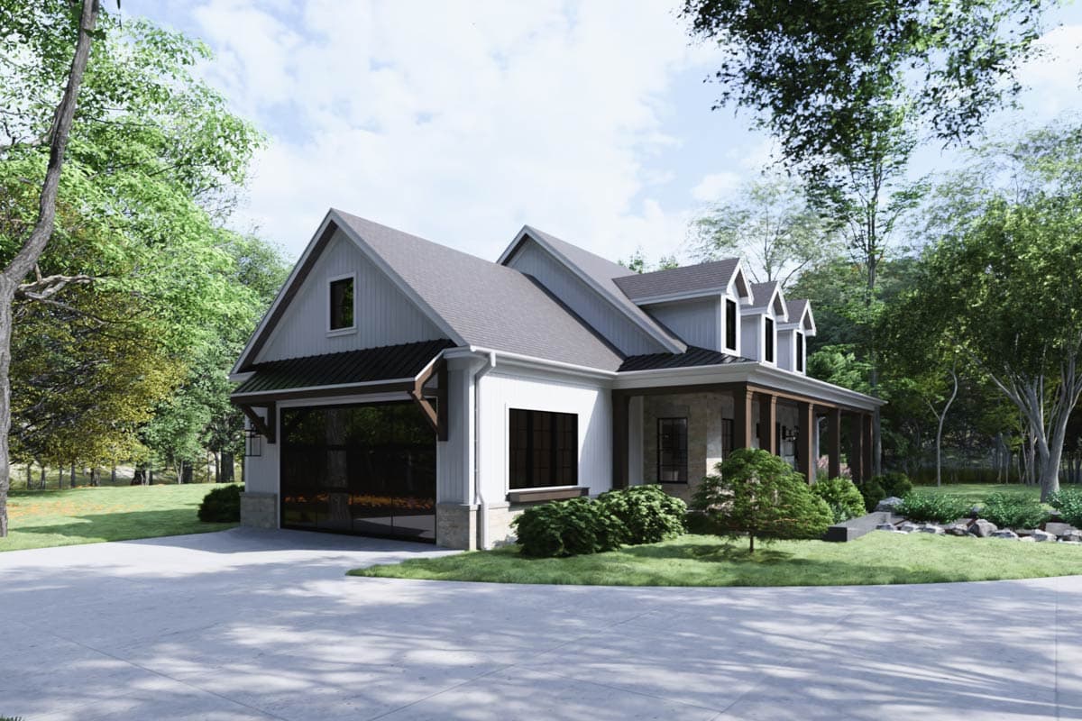 A modern farmhouse style house with a large glass garage door sits on a concrete driveway. Trees surround the exterior on a sunny day.