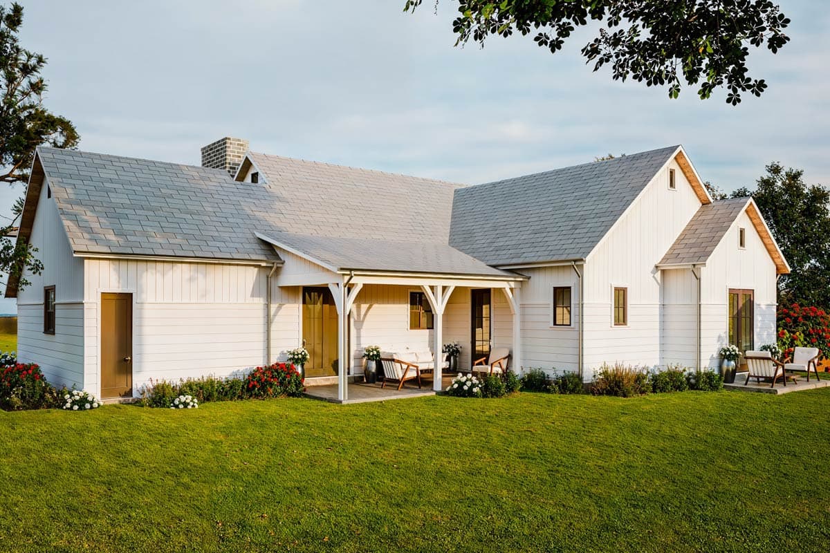 Modern Farmhouse style house plan exterior with a gabled roof, covered front porch, and brick chimney.