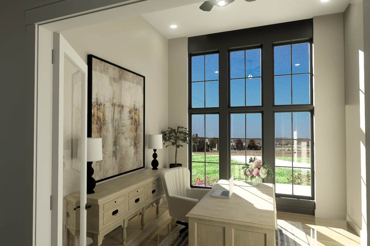 A well-lit home office with a large window overlooking a scenic view. A desk, chair, and art piece complement the room's elegant design.