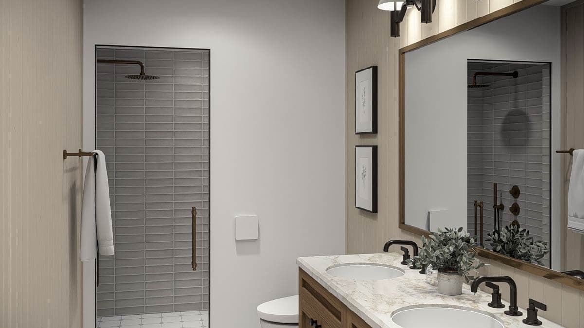 Bathroom with double vanity, marble countertop, glass-enclosed shower with subway tile, and brass fixtures.