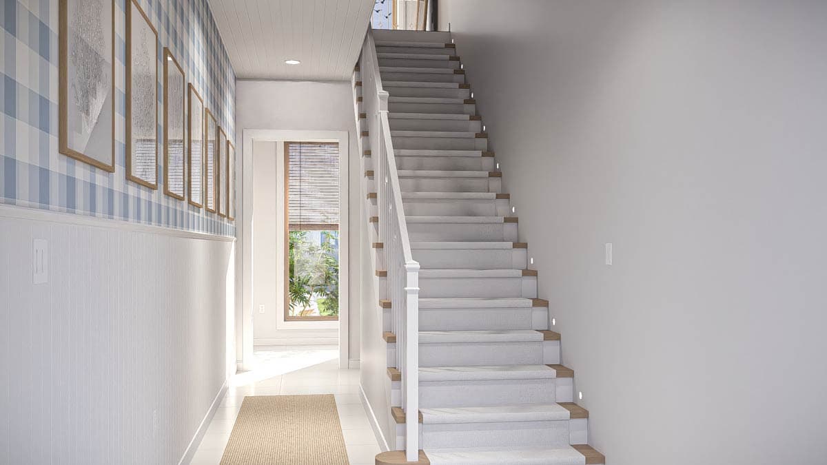 House plan interior view of a staircase with carpeted treads, wood accents, and sconce lighting. Blue buffalo check wallpaper adorns the left wall.