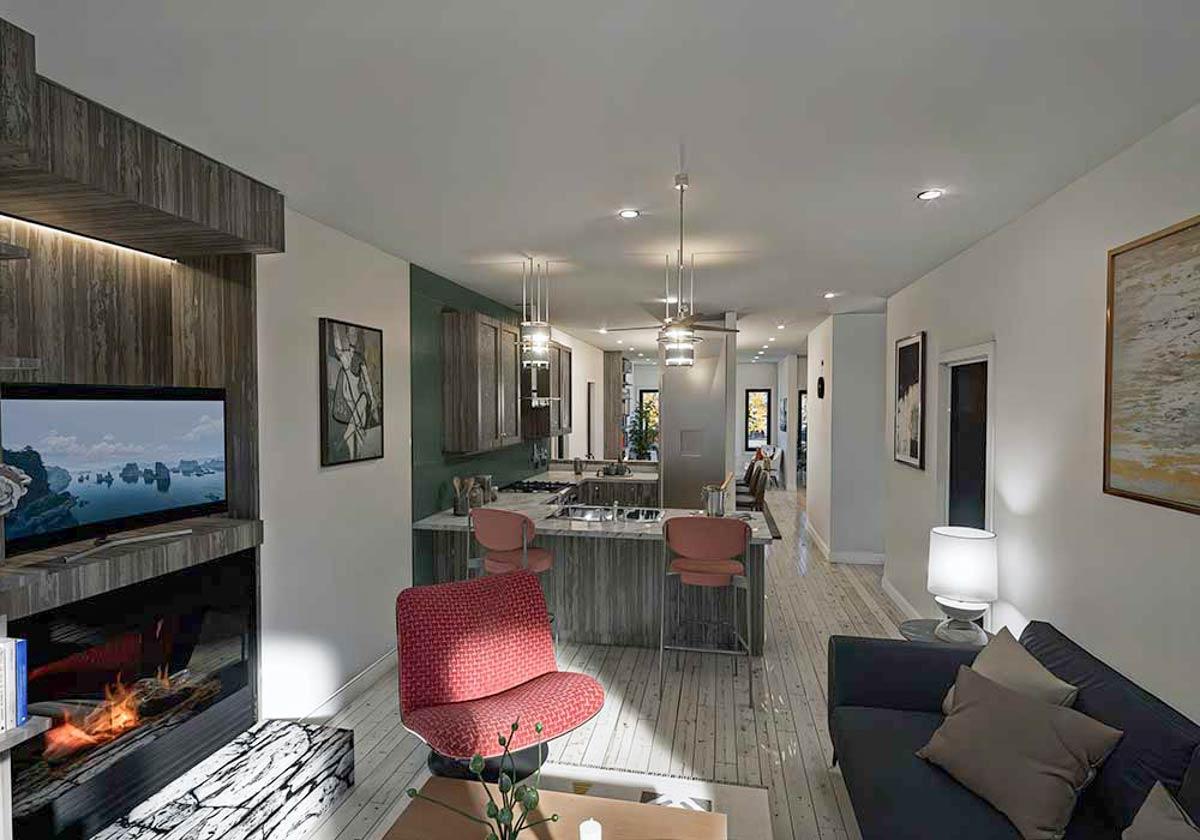 Interior rendering showing an open-concept living and kitchen area with a fireplace, island, and bar seating.