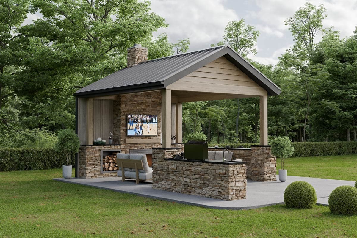 Outdoor kitchen with stone-clad structure, fireplace, television, grill, and covered gable roof.