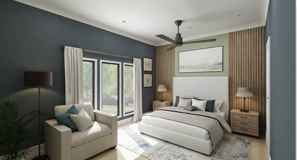 Primary bedroom with bed, bedside tables, armchair, floor lamp, ceiling fan, and large windows.