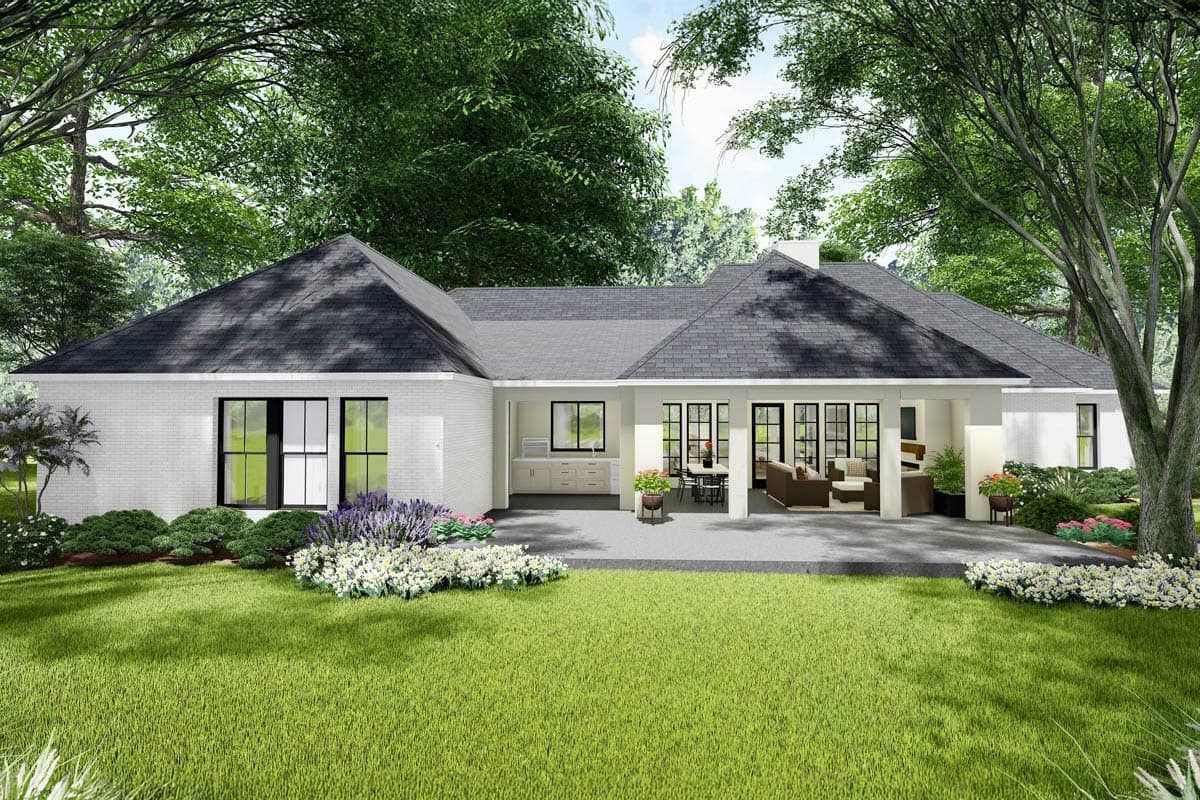 House plan exterior: single-story home with white brick, gabled roof, covered patio with outdoor kitchen and seating area.