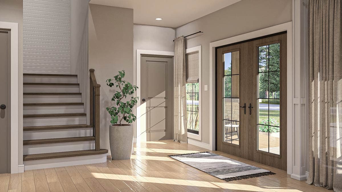 Interior view of house entry: stairs, double wood doors with grid panes, and a potted plant.