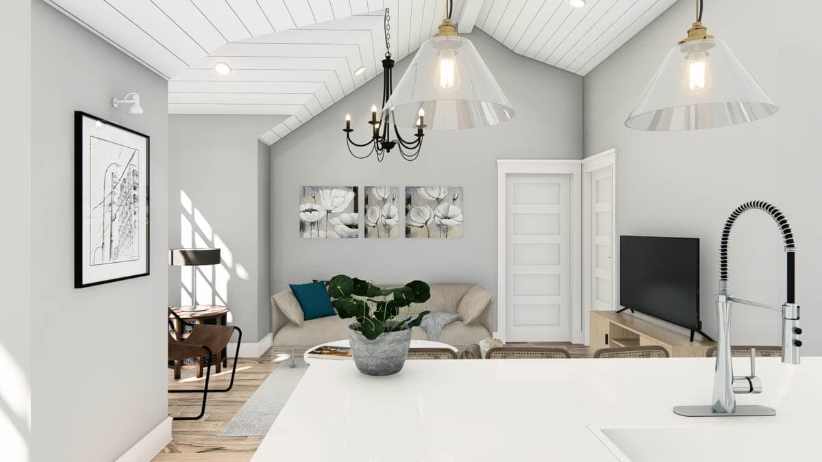 Interior view of a living area with vaulted ceiling, sofa, and a wall-mounted TV.
