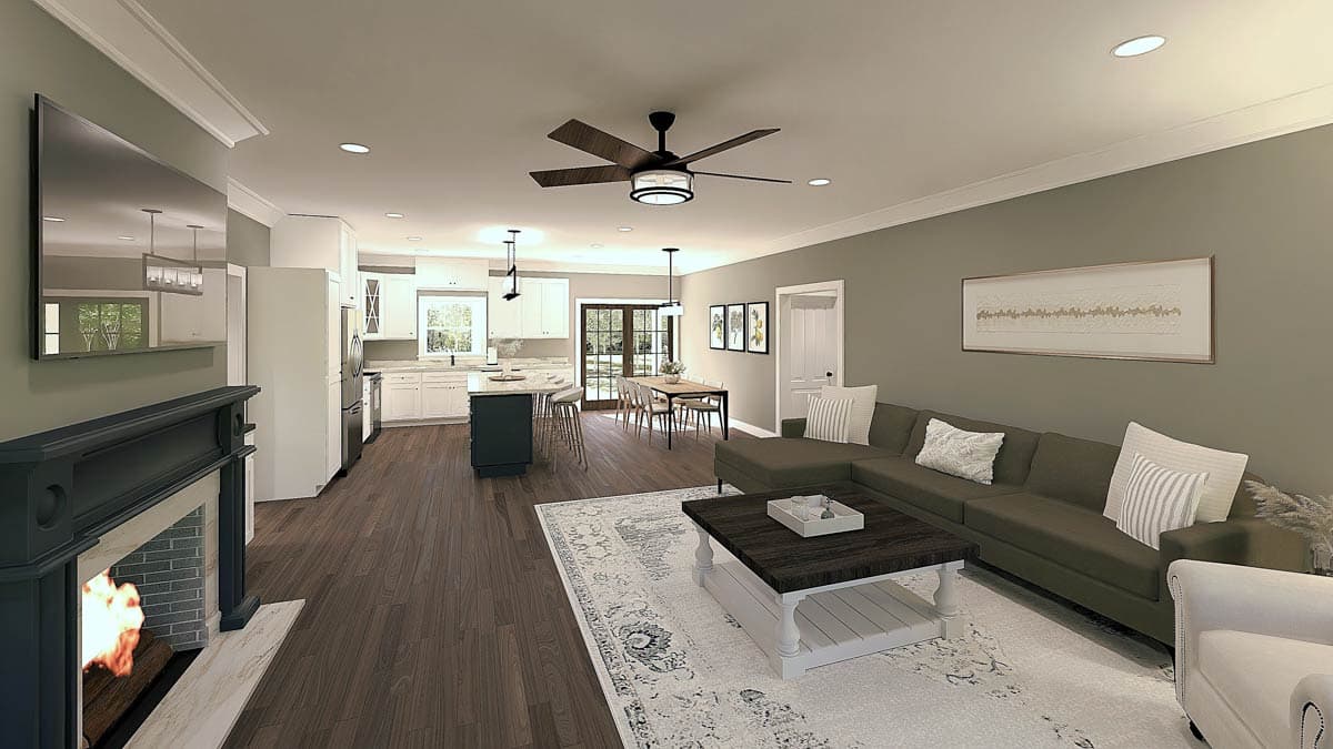 Living room and kitchen with fireplace, island seating, dining table with French doors, and sectional sofa.