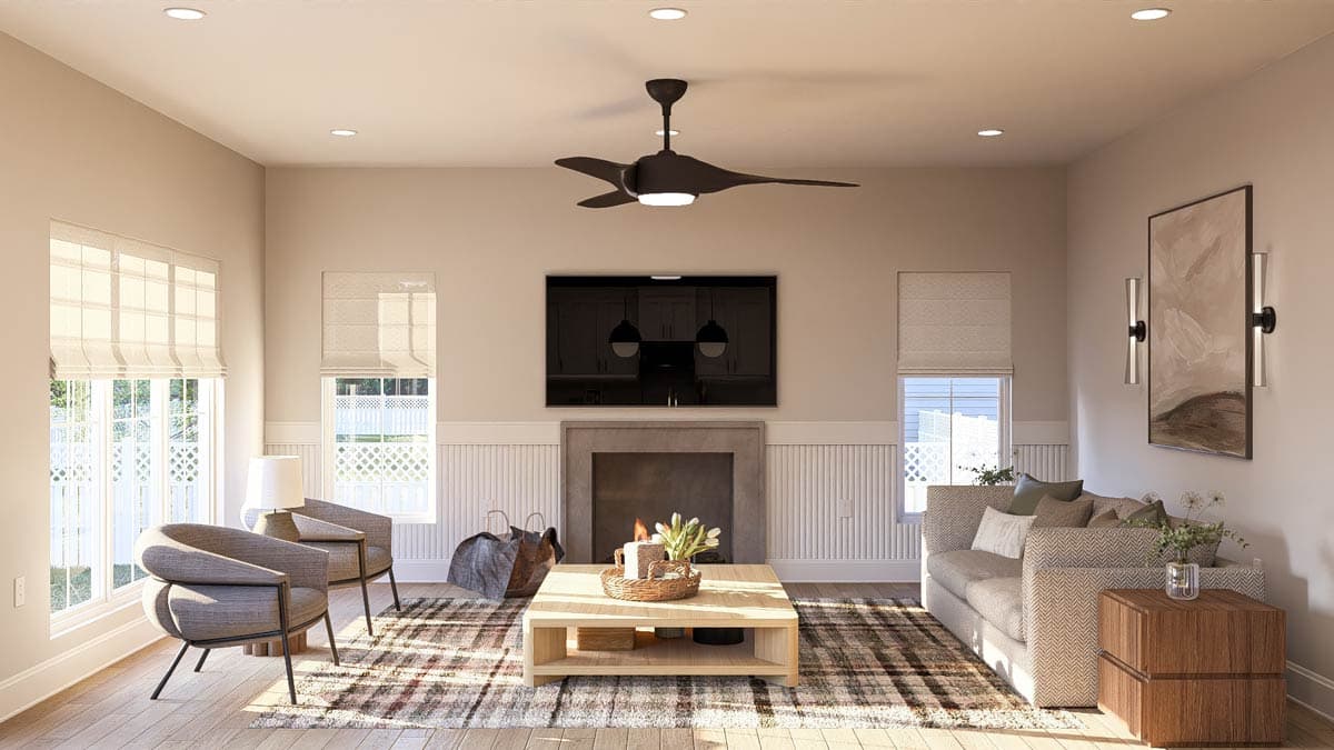 Living room with fireplace, TV, seating, coffee table, and large windows with decorative grilles.
