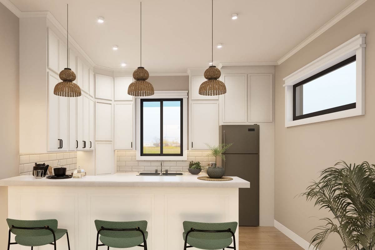 Kitchen with white cabinets, a breakfast bar with pendant lights, stainless steel appliances, and subway tile backsplash.