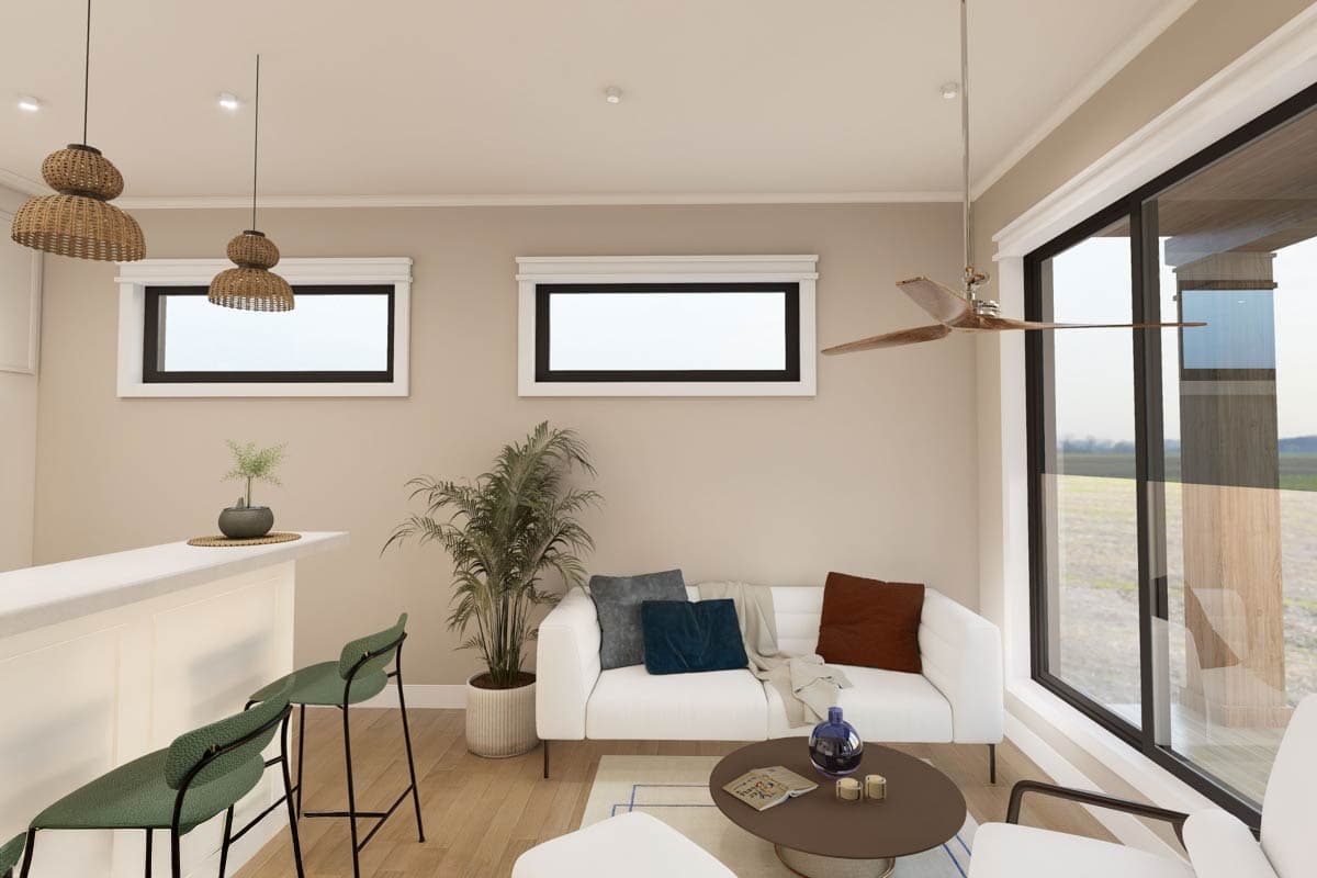 Interior rendering of a great room with a white sofa, bar, and large windows overlooking a field.