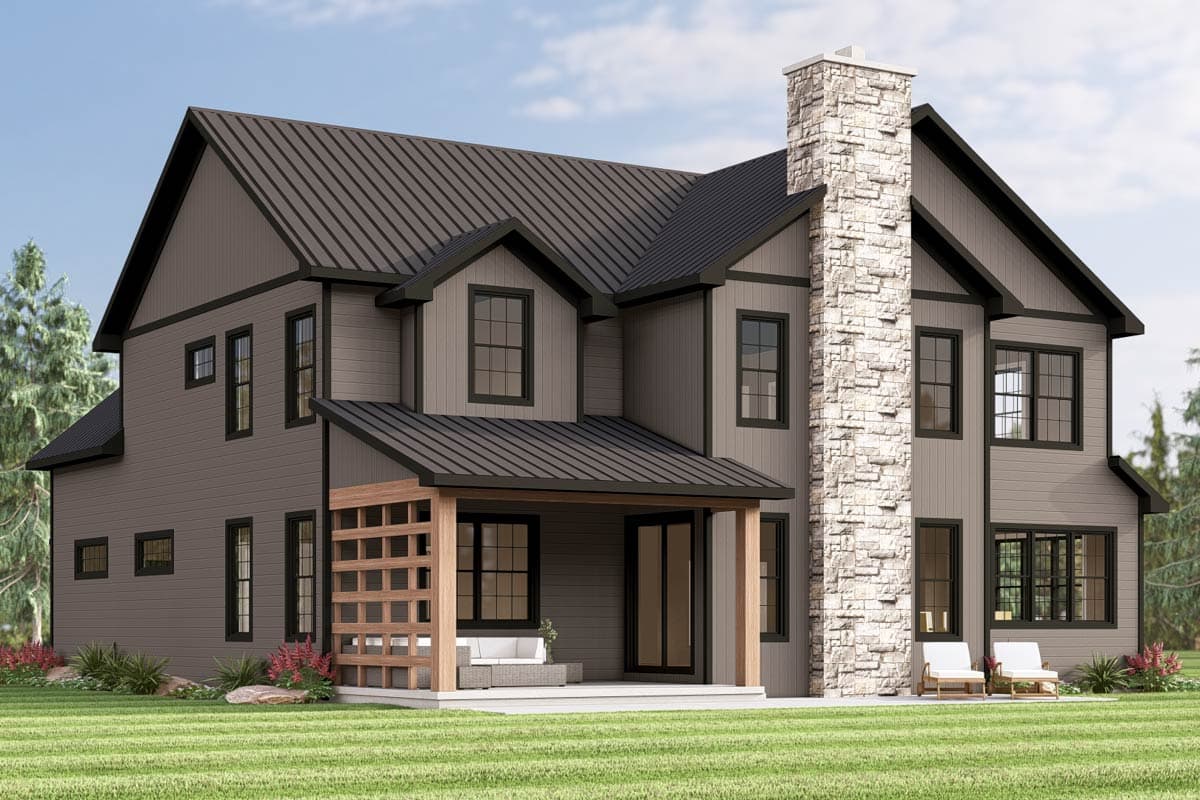 Two-story Modern Farmhouse exterior with metal roof, stone chimney, gabled dormers, and covered patio with wood trellis.