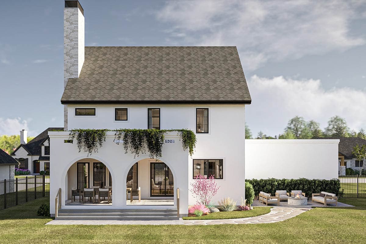 Modern house plan exterior with arched loggia, second-story balcony with hanging plants, and tall brick chimney.