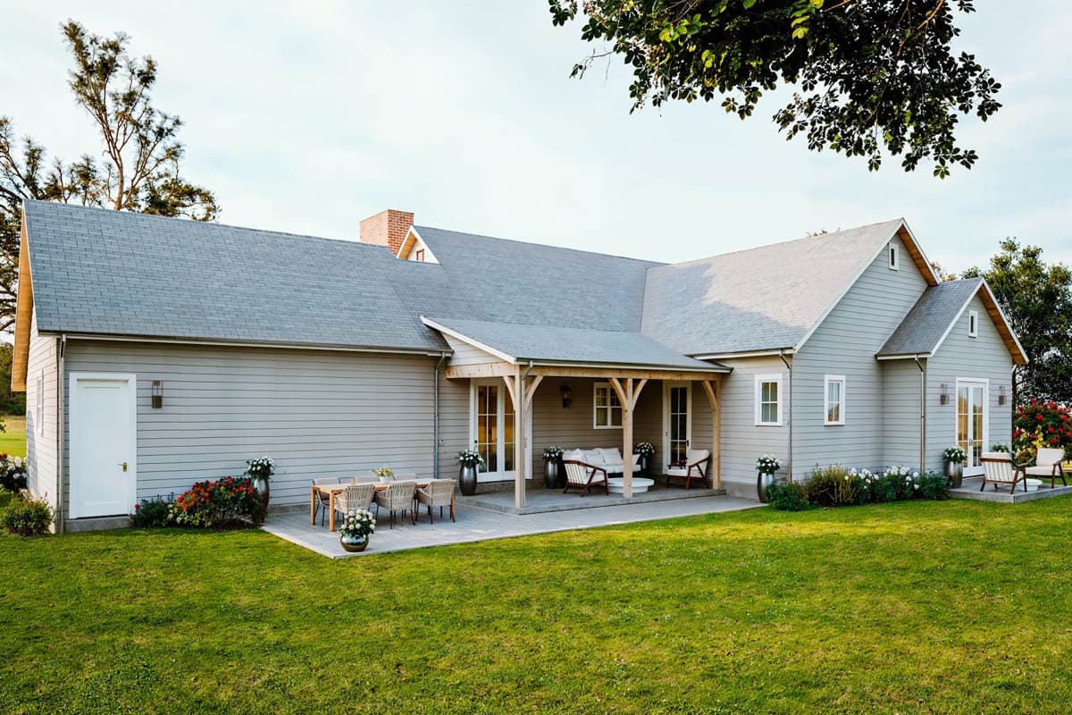 House plan exterior: Ranch style, single-story home with a covered porch, gabled dormer, and horizontal siding.