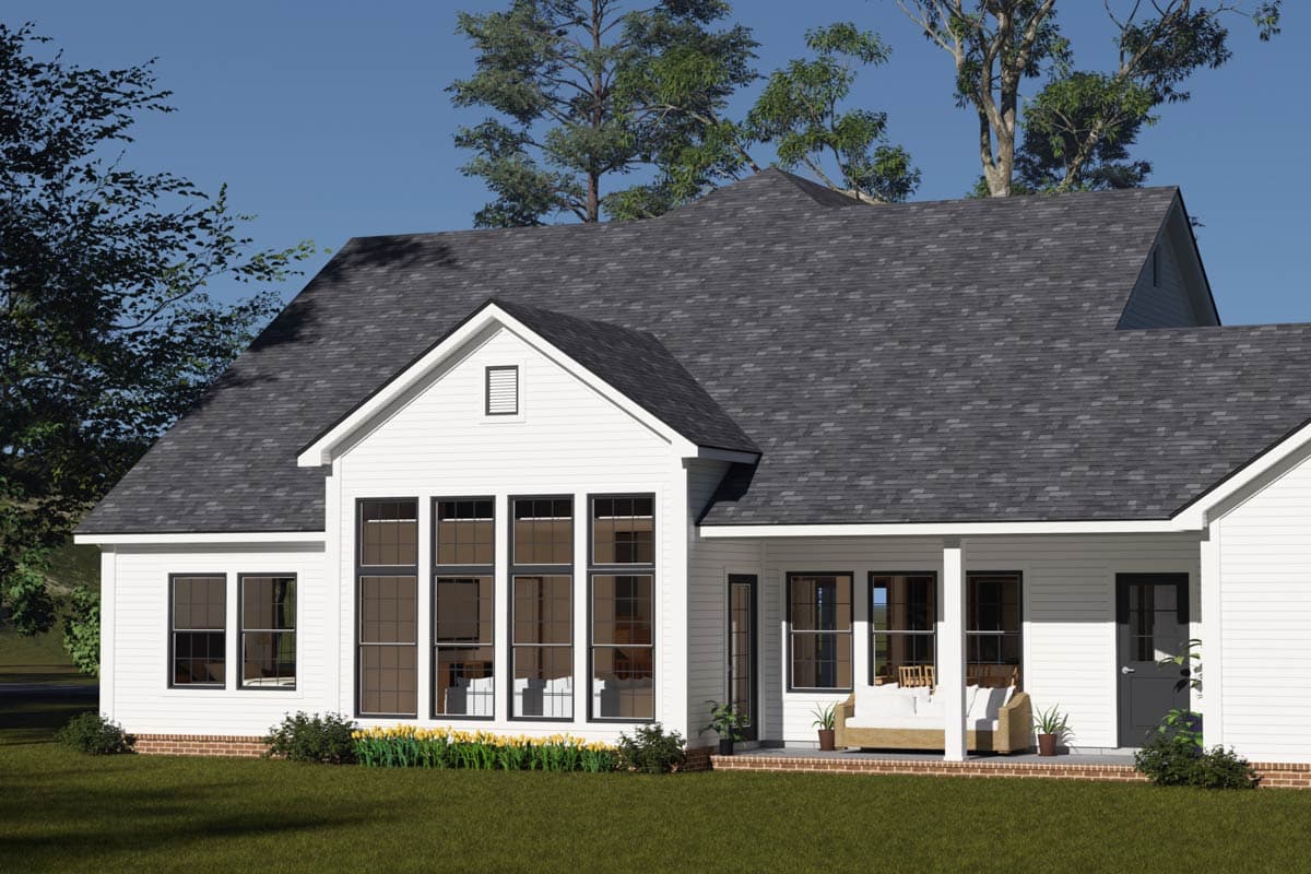 House plan exterior: Modern Farmhouse style, two stories, prominent gable, large window wall, covered porch.