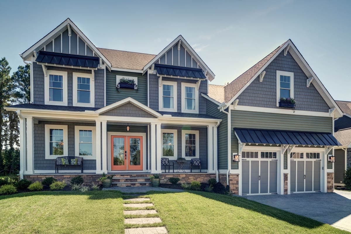 House plan exterior featuring a two-story Craftsman style. Notable features: gabled rooflines, covered porch, and a side-entry garage.