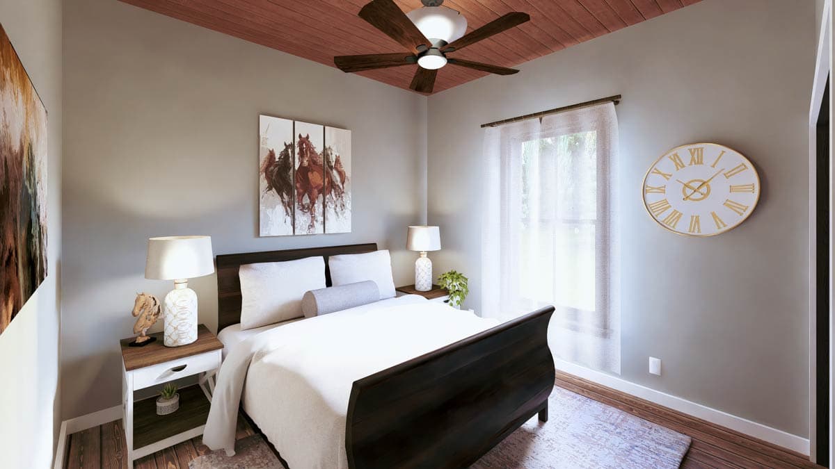 Interior view of a bedroom with a queen bed, wood-paneled ceiling, ceiling fan, and a large round clock.