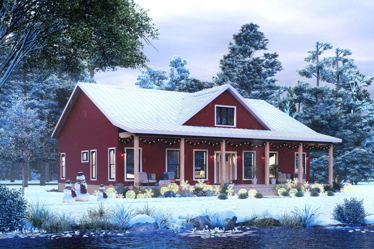 A festive red house with snow-covered roof and porch. Snowmen and festive lights adorn the snowy yard. The scene is wintery with a water feature in the foreground.