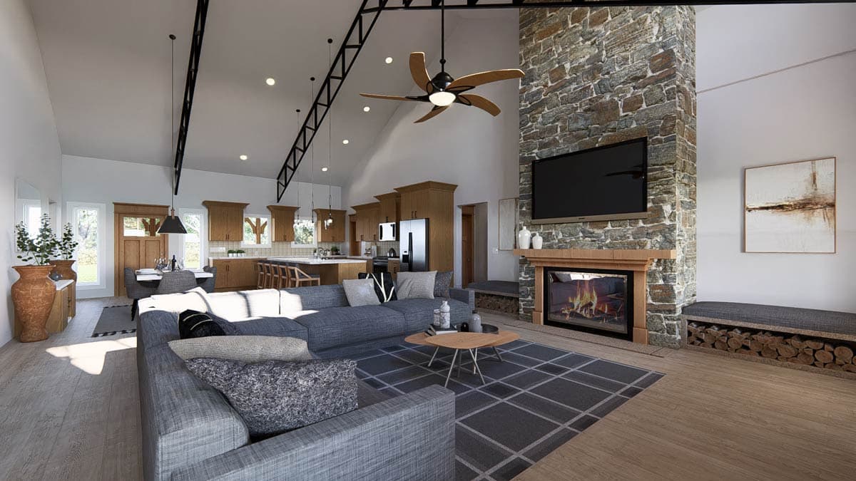 Open concept living space with vaulted ceiling, exposed beams, stone fireplace, kitchen island, and dining area.