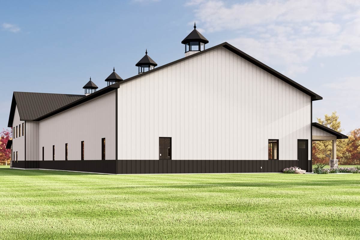 House plan exterior showing a barn-style structure with white vertical siding, dark metal roof, cupolas, and a covered porch.