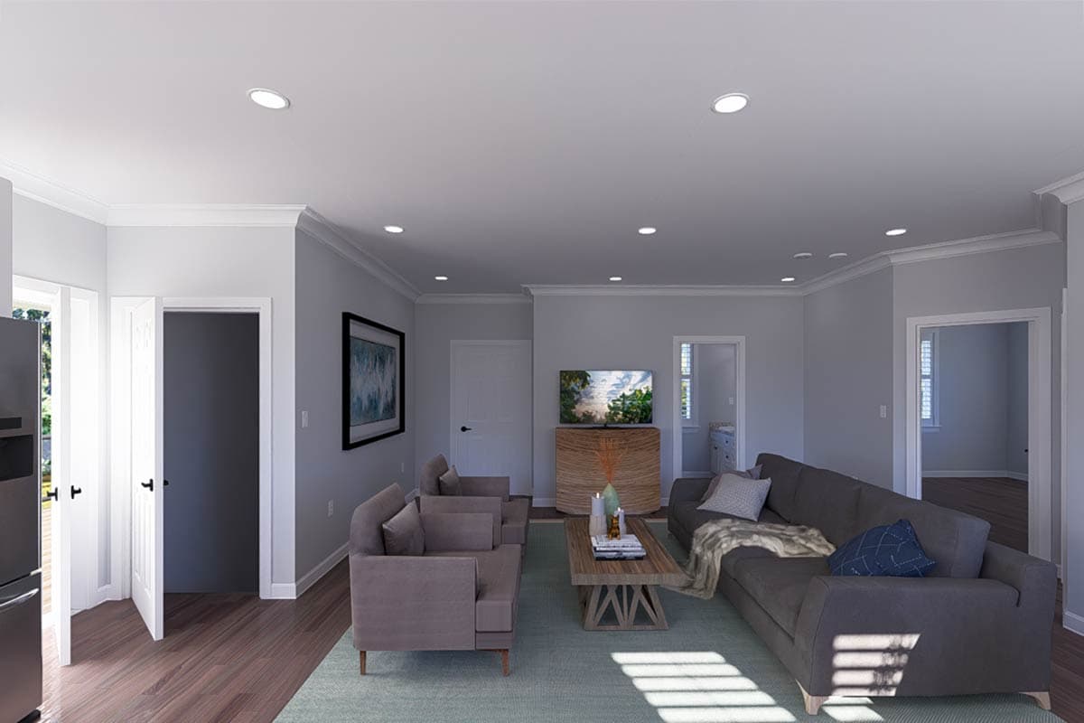 Living room with sofas, coffee table, entertainment center, and doorways to other rooms.