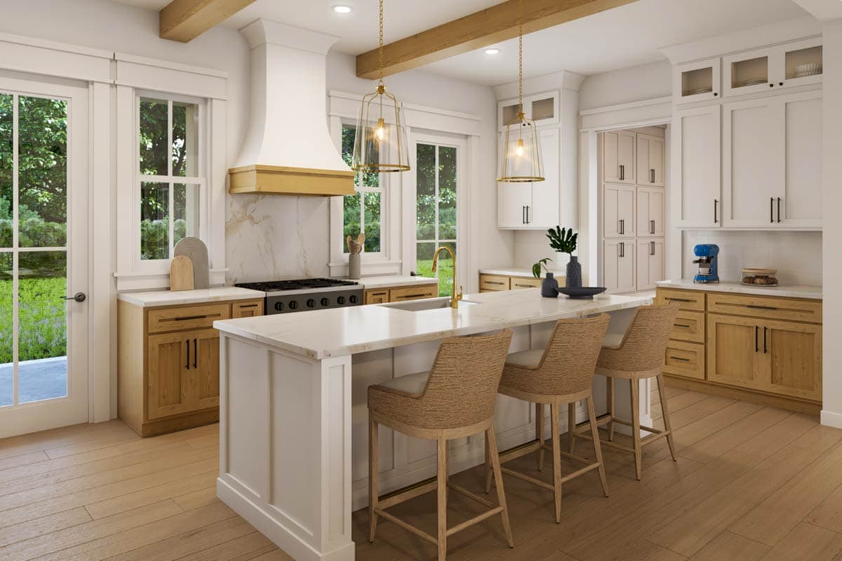 Kitchen with island seating, white cabinets, natural wood lower cabinets, island with white perimeter, stainless steel range, and pendant lights.
