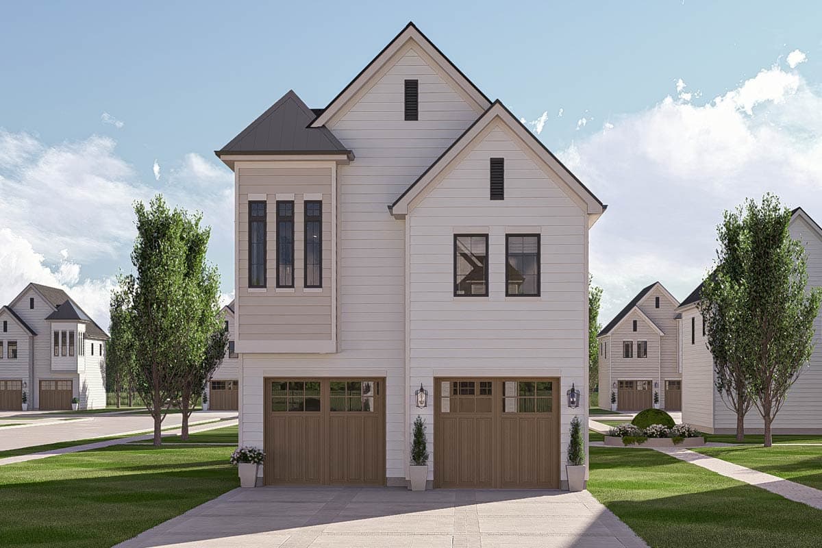 House plan exterior with two stories, a gabled roof, and a bay window. Features include a two-car garage with carriage-style doors.