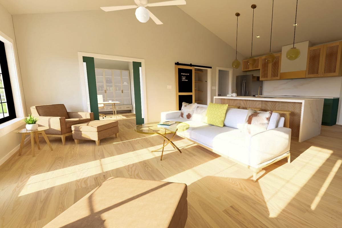 Open-concept living and kitchen area with vaulted ceiling, island, and sliding barn door to office.