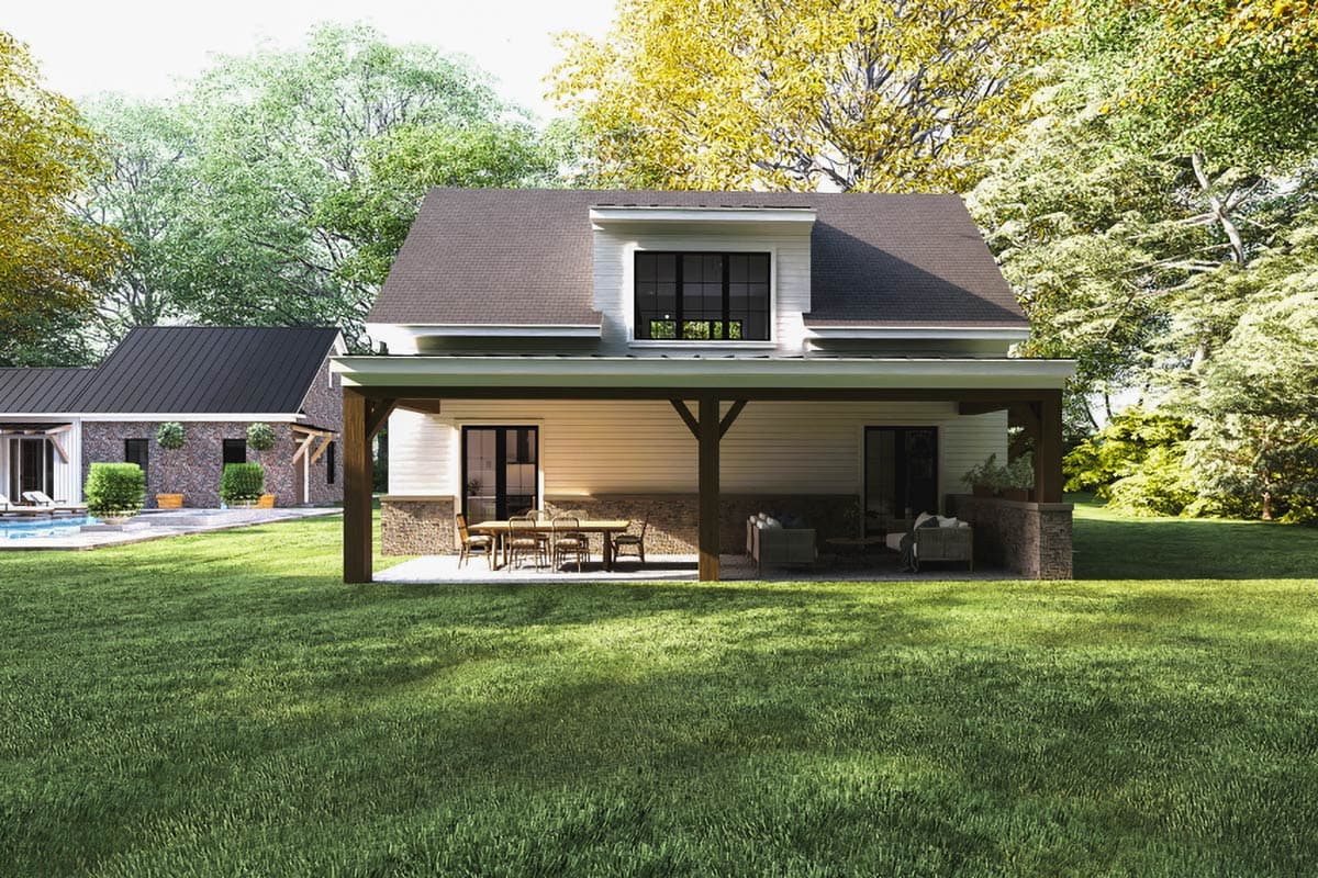 Modern Farmhouse house plan exterior, two stories, covered porch with outdoor dining and seating, prominent dormer.