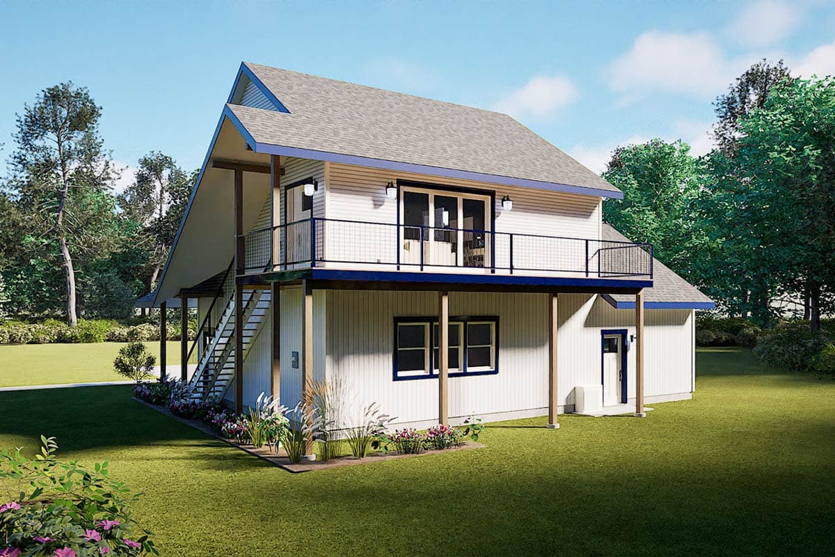 A two-story white house with a gray roof and blue trim. It features a balcony, exterior stairs, and is surrounded by a lawn and trees.