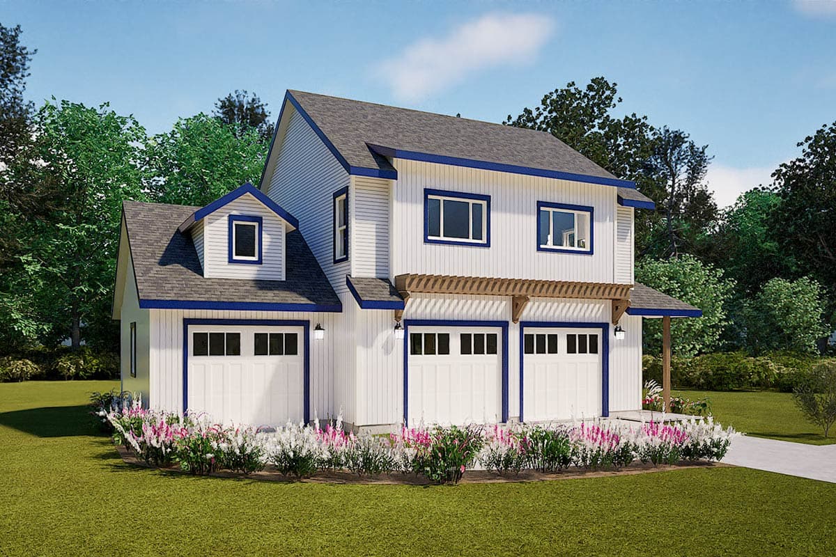 A two-story white house with blue trim and a three-car garage, surrounded by greenery and a vibrant flower bed, on a sunny day.