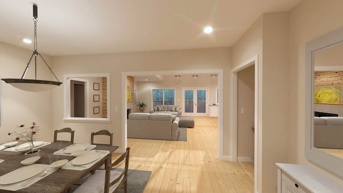 Dining area with pendant light, looking into living room with fireplace and French doors to exterior.