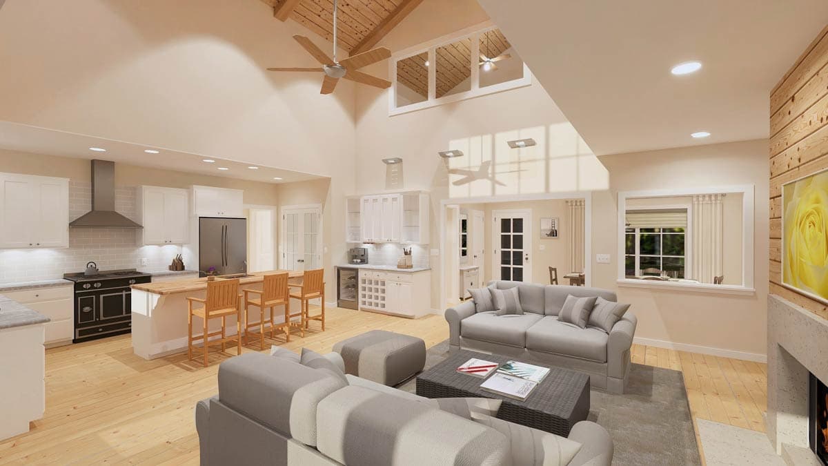 Open concept living area with vaulted wood-beamed ceiling, kitchen island with bar stools, and fireplace.
