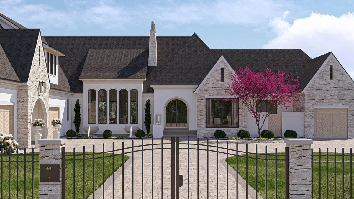 House plan exterior featuring a stone facade, multi-level rooflines, arched entryways, and a detached garage.