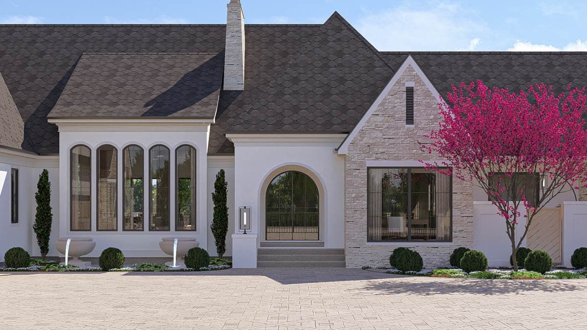 House plan exterior: Two-story residence with stone accents, arched entryway, multiple gables, and tall arched windows.