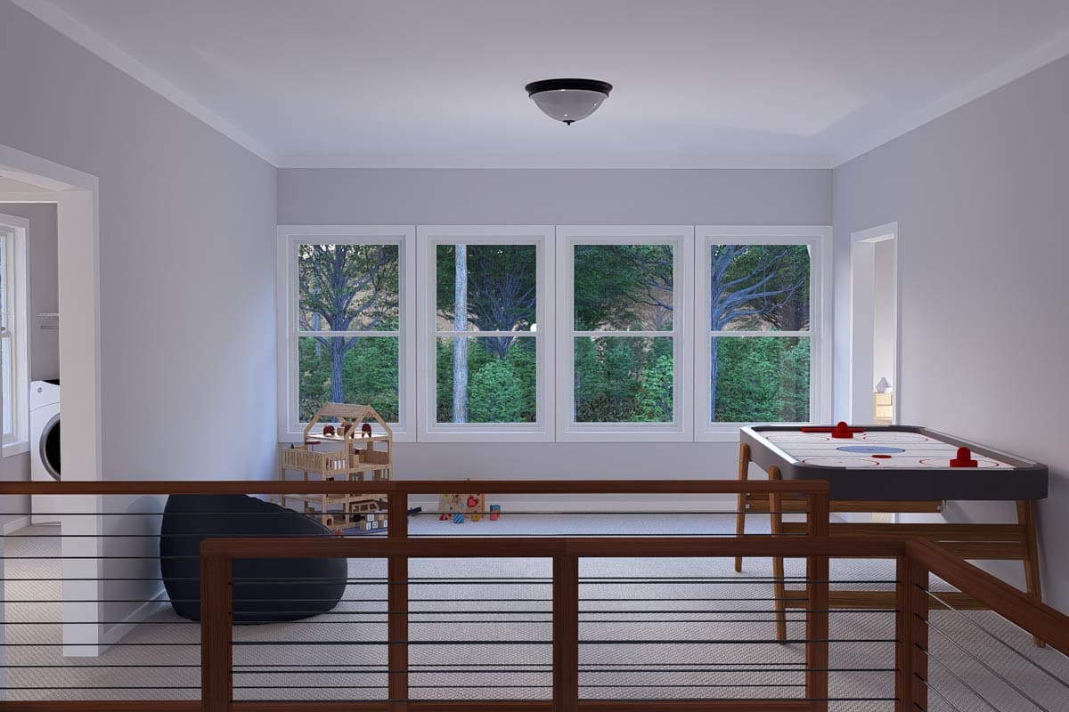 Playroom with air hockey table, dollhouse, laundry area, and four large windows overlooking trees.