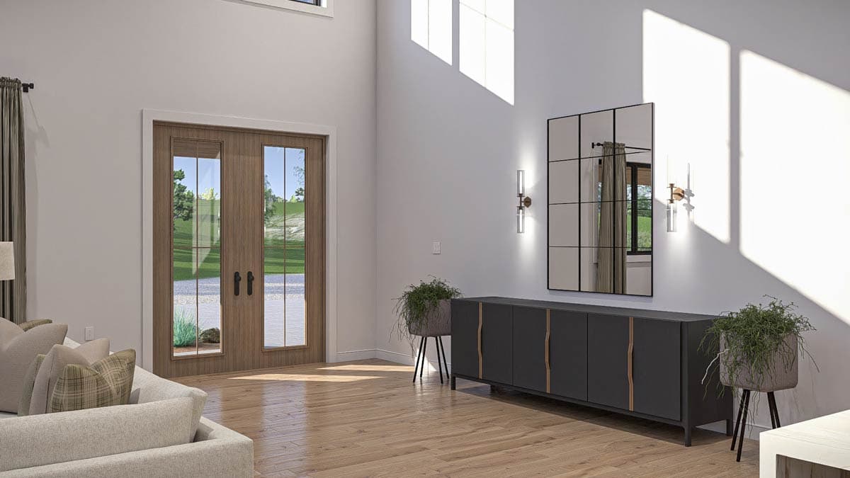 Interior view with double glass doors, tall windows, console table, and wall mirror.