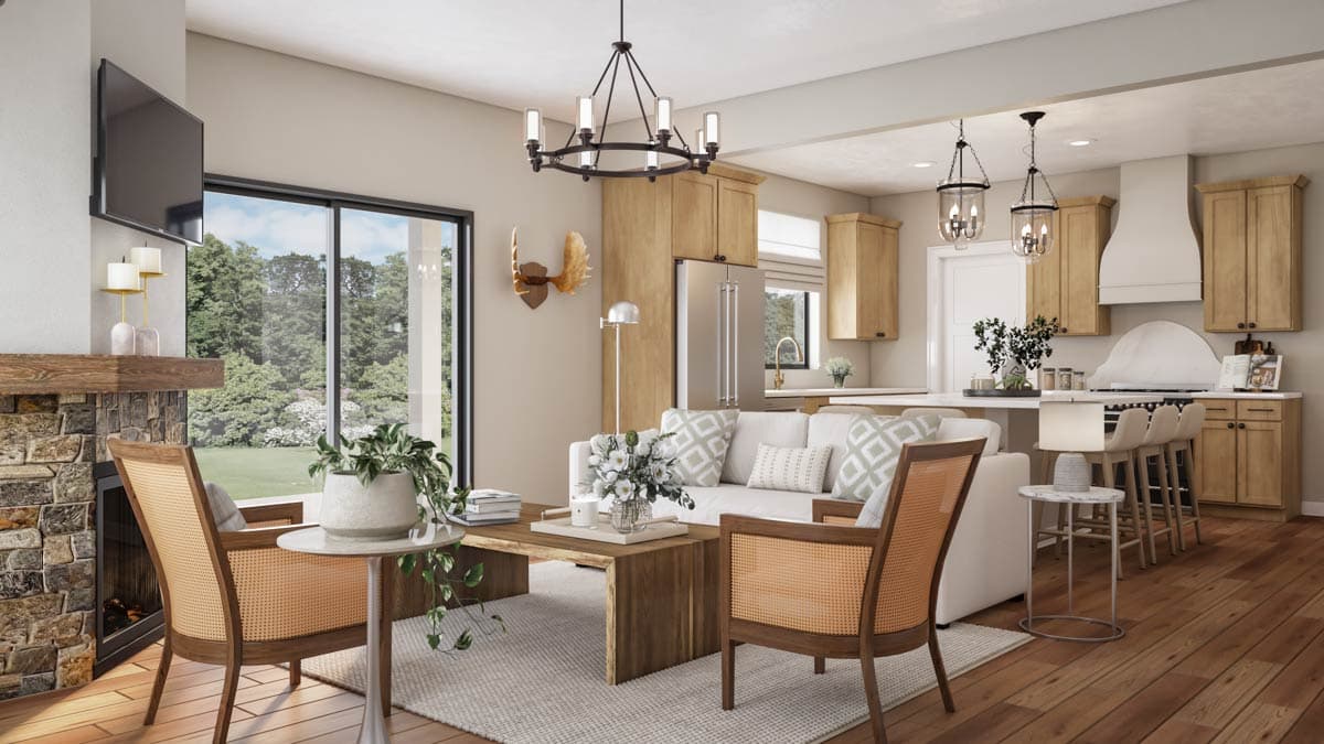Living room and kitchen open layout with stone fireplace, wood cabinetry, island with seating, and large windows.