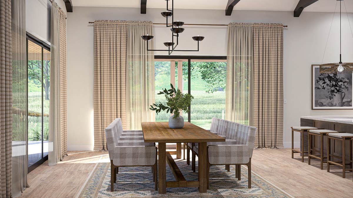 Dining room with wooden table, checkered chairs, beamed ceiling, large windows, and kitchen island with bar stools.