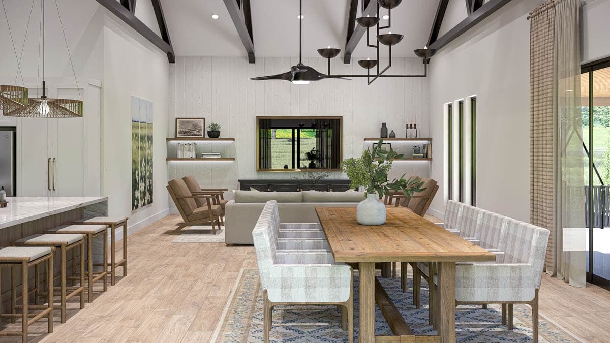 Great room and kitchen open layout with vaulted ceiling, exposed beams, island, and dining area.