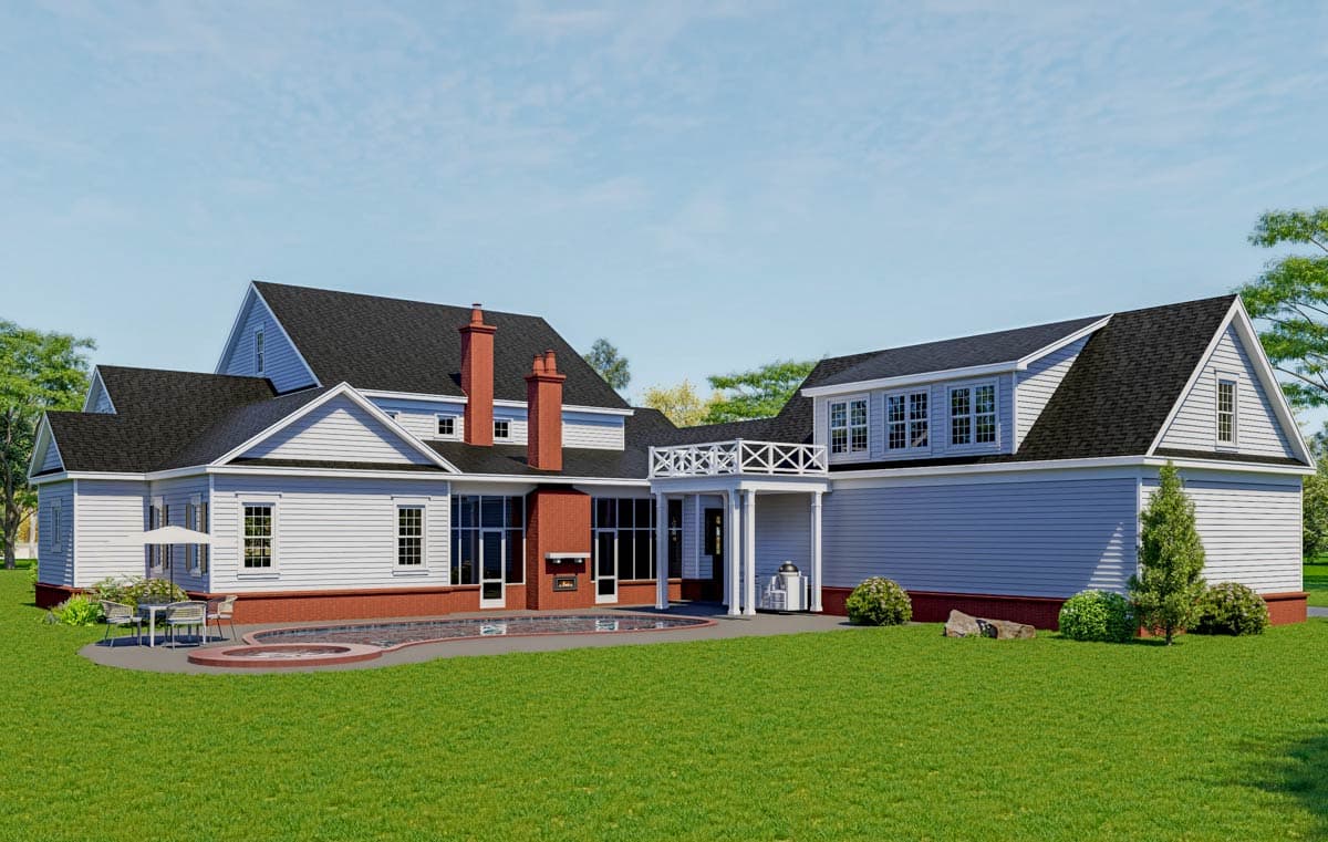 House plan exterior with multiple gables, dormer windows, large brick chimneys, and a covered porch with decorative railing.