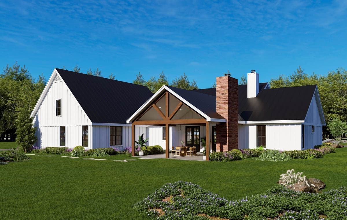 Modern Farmhouse house plan exterior with white board and batten siding, black metal roof, stone chimney, and covered outdoor living space.