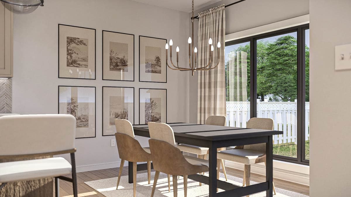 Dining room with table and chairs, wall art, chandelier, and large window overlooking a white picket fence and trees.