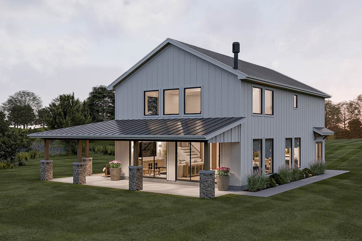 Modern farmhouse exterior with gabled roof, covered patio supported by stone piers, and board-and-batten siding.