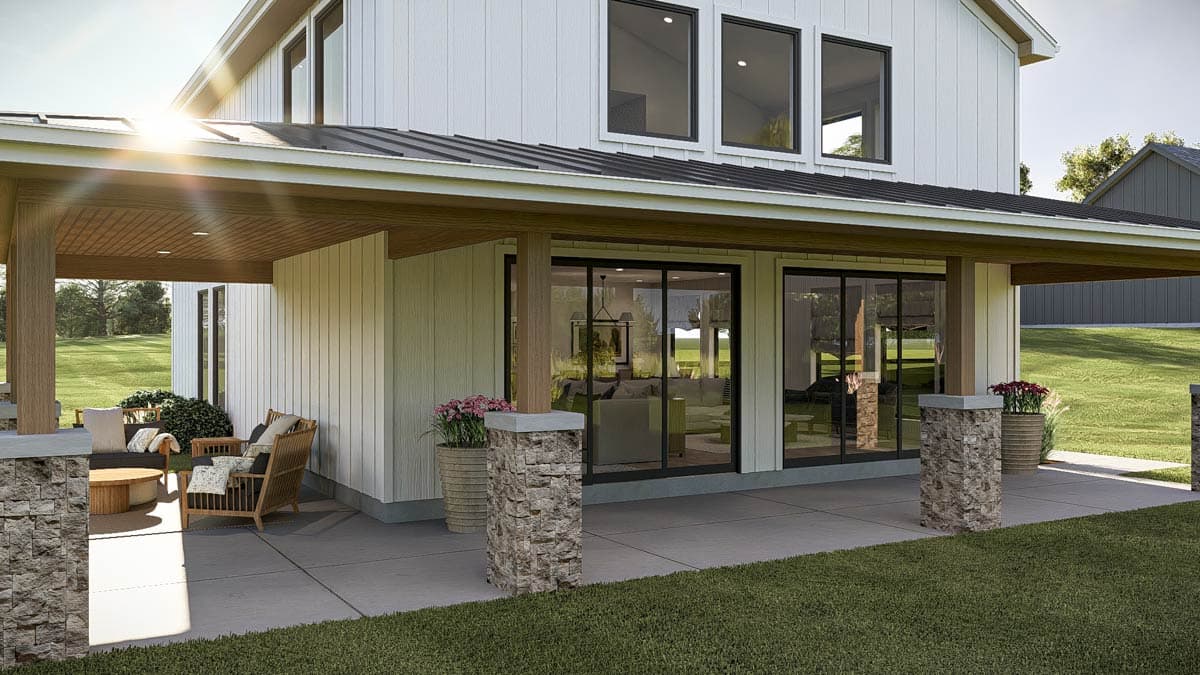 Modern Farmhouse house plan exterior with white vertical siding, black metal roof, and covered porch with stone-clad columns.