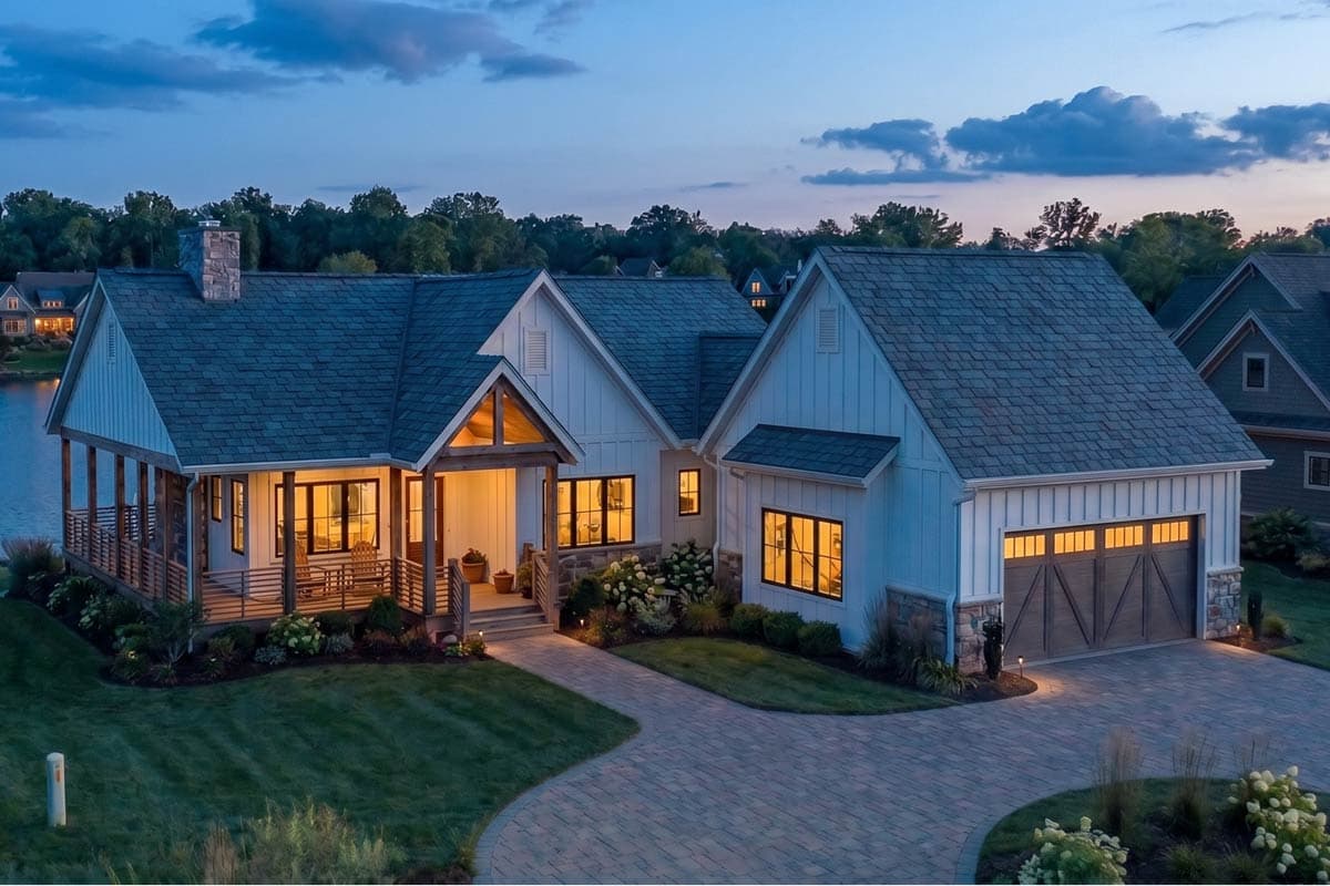 Modern Farmhouse house plan exterior with a wrap-around porch, stone chimney, board and batten siding, and a two-car garage.