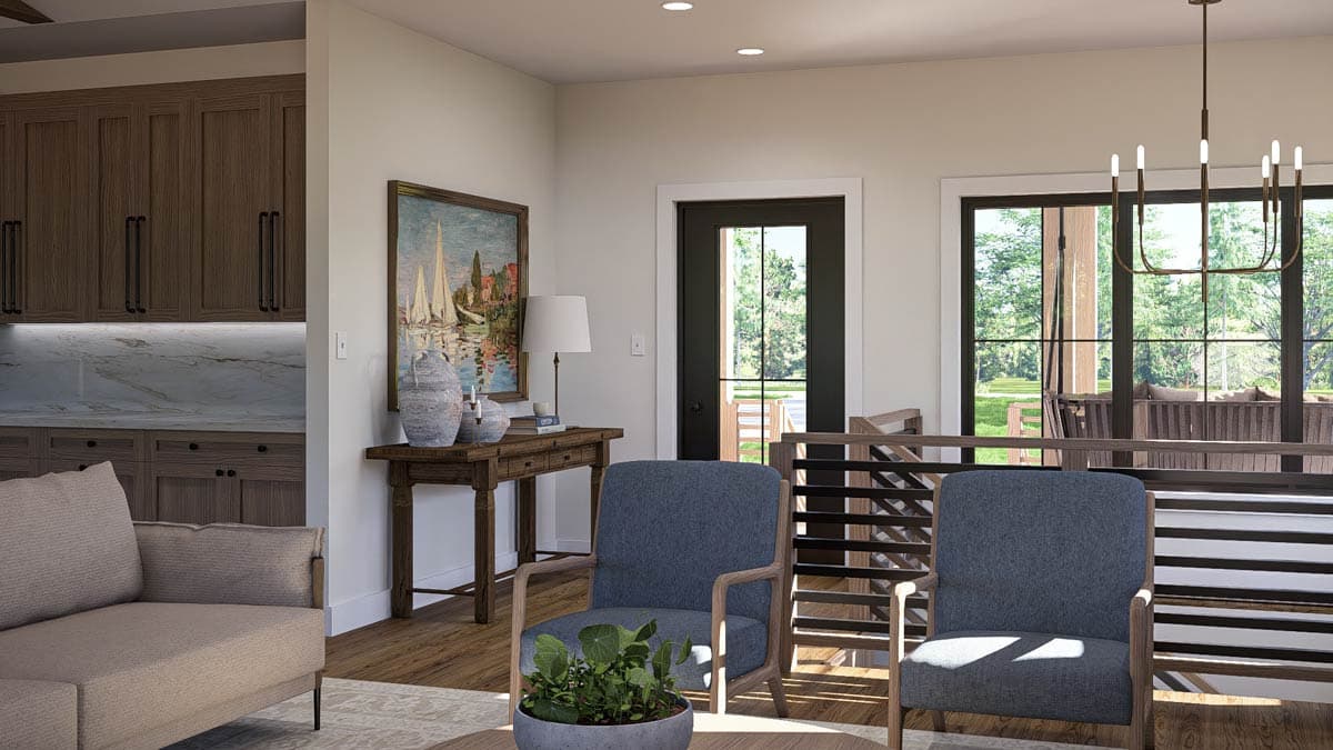 Living area with wood cabinetry, marble countertops, seating, and large windows overlooking outdoor space.