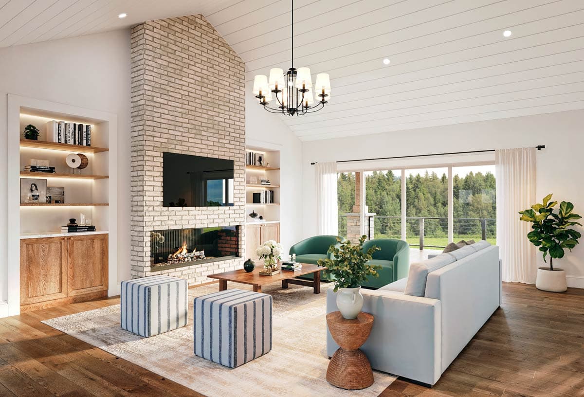 Modern living room with vaulted ceiling, floor-to-ceiling brick fireplace, built-in shelving, and large windows with forest view.