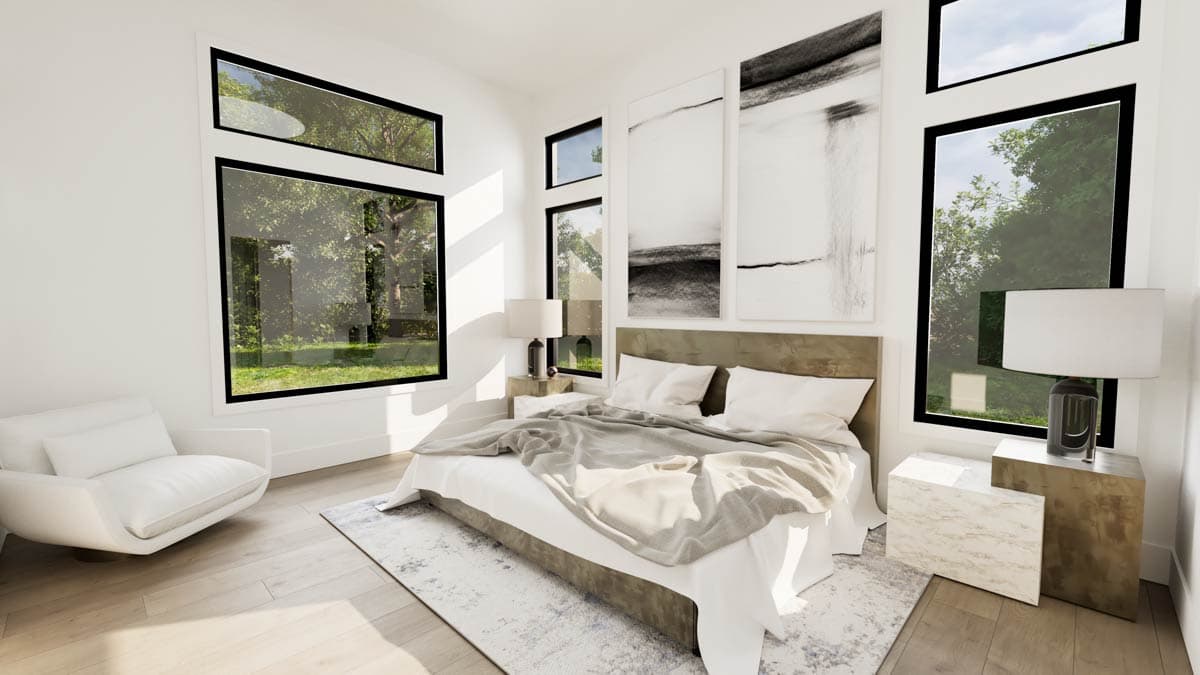 Modern master bedroom with large windows overlooking trees, a bed, armchair, and abstract art pieces on the wall.