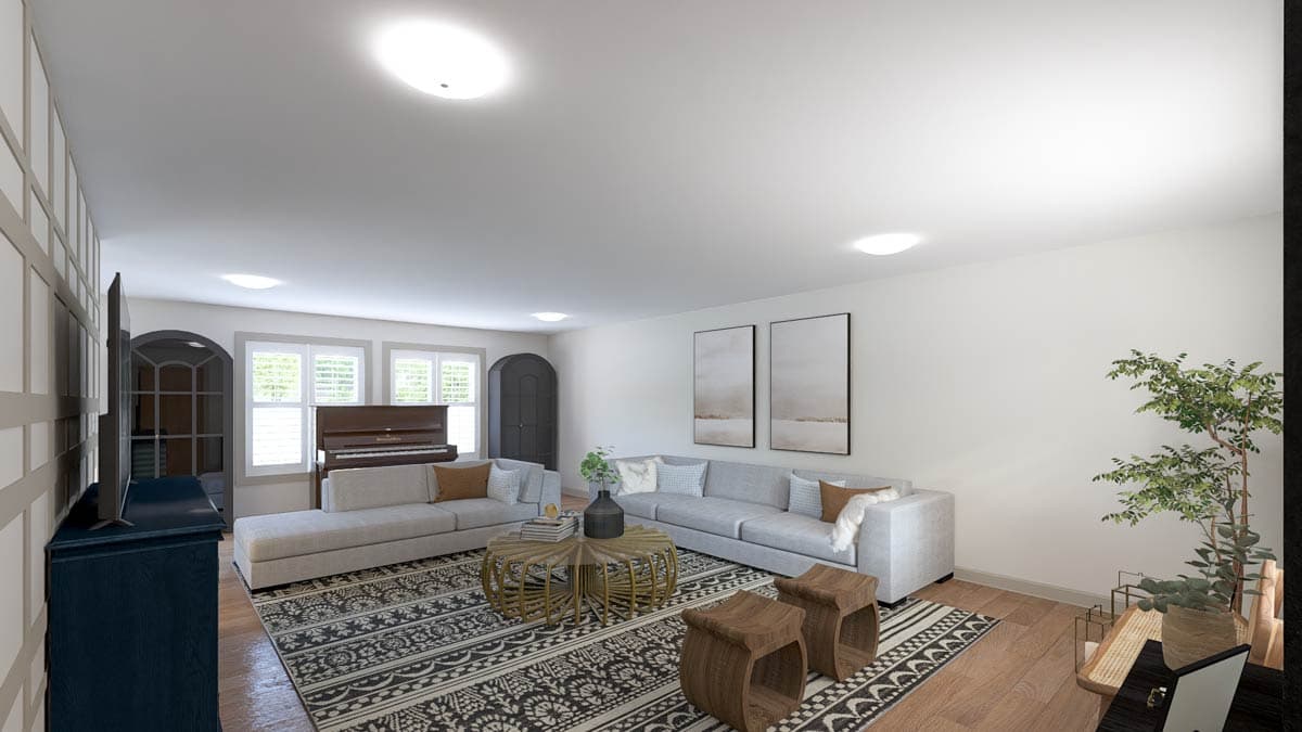 Living room with sectional sofas, piano, coffee table, and patterned rug.